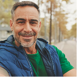 mature-man-sitting-on-bench-in-the-park-talking-2024-10-17-06-55-07-utc