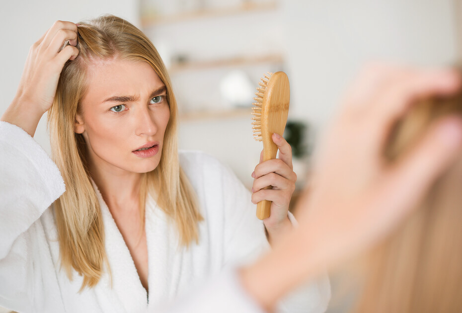worried-blonde-woman-checking-hair-roots-near-mirr-2025-03-18-16-50-10-utc (1)